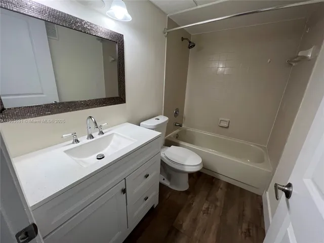 a bathroom with a double vanity sink toilet and shower