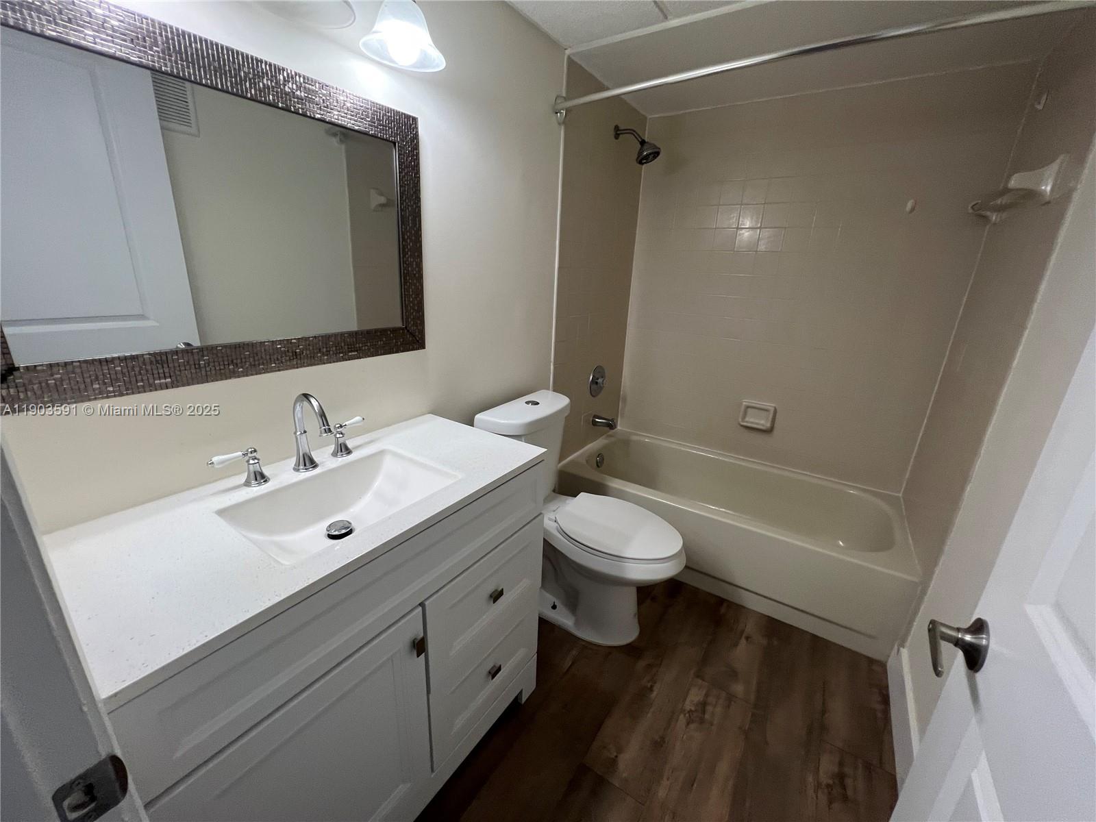 8120 Geneva Court, Unit 554 Doral, FL 33166 - Photo 23 of 32 a bathroom with a double vanity sink toilet and shower