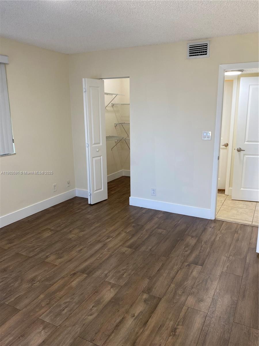 8120 Geneva Court, Unit 554 Doral, FL 33166 - Photo 31 of 32 a view of an empty room and wooden floor