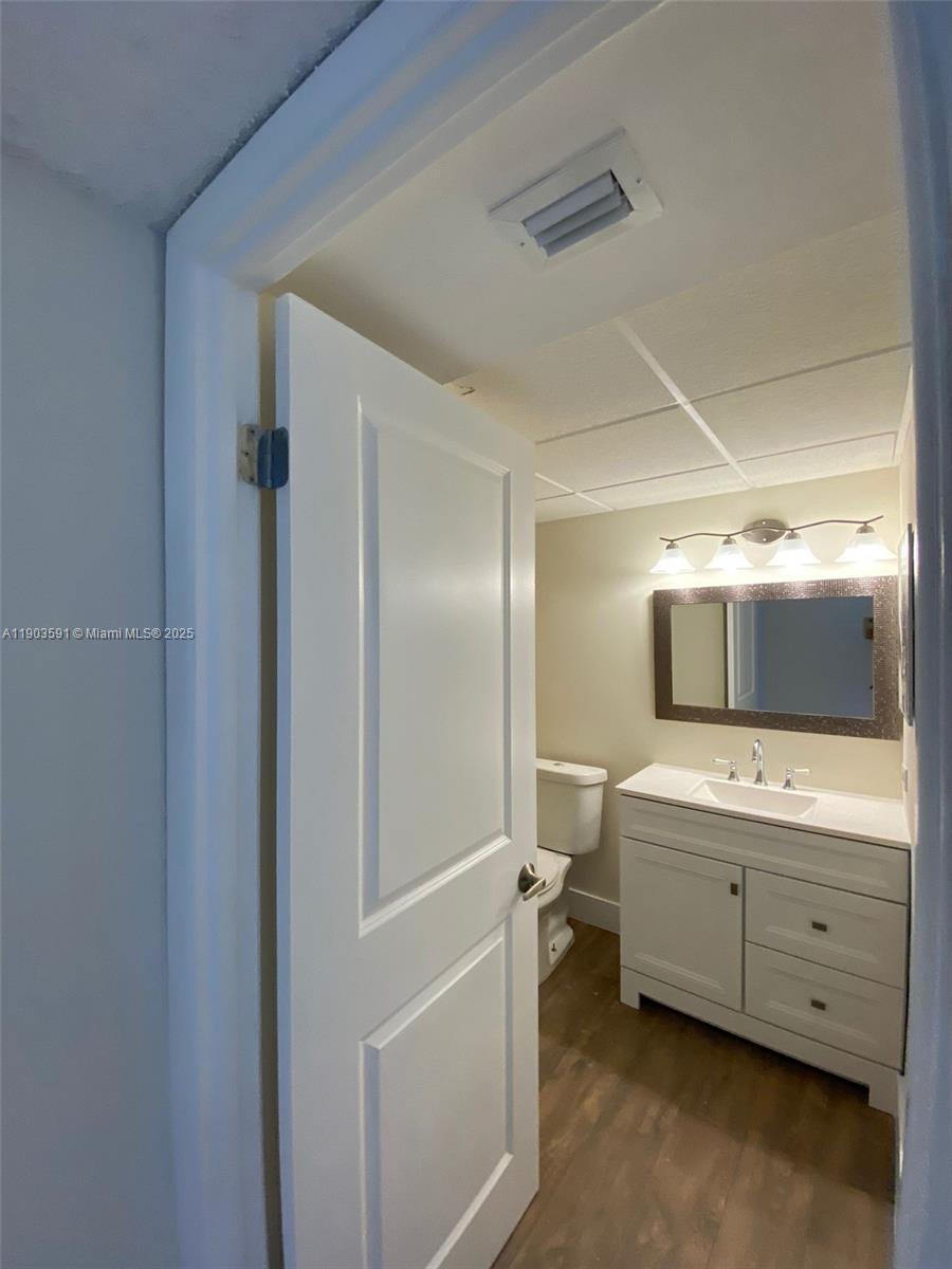 8120 Geneva Court, Unit 554 Doral, FL 33166 - Photo 10 of 32 a bathroom with a double vanity sink and mirror