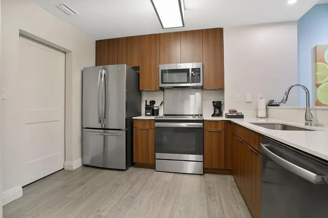 a kitchen with a refrigerator sink and microwave