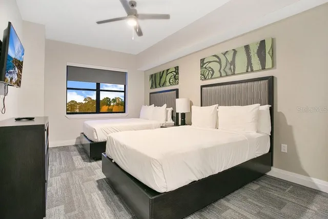 a bed room with a bed and a flat screen tv