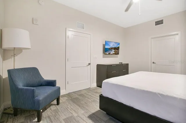 a bedroom with a bed couch and a window