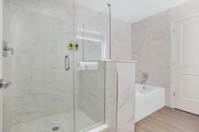 a bathroom with a bathtub and a shower