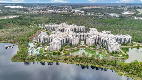 an aerial view of a house with a lake view