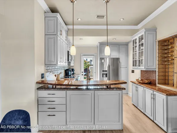a kitchen with stainless steel appliances a sink and cabinets