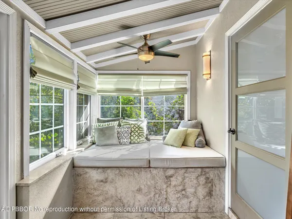 a living room with a couch and floor to ceiling windows