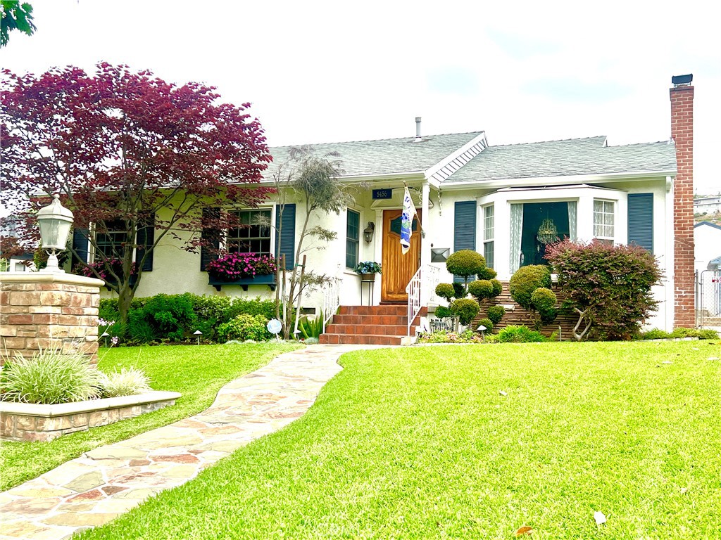 5456 Cadbury Road Whittier, CA 90601 - Photo 1 of 67 a view of a house with swimming pool and a garden