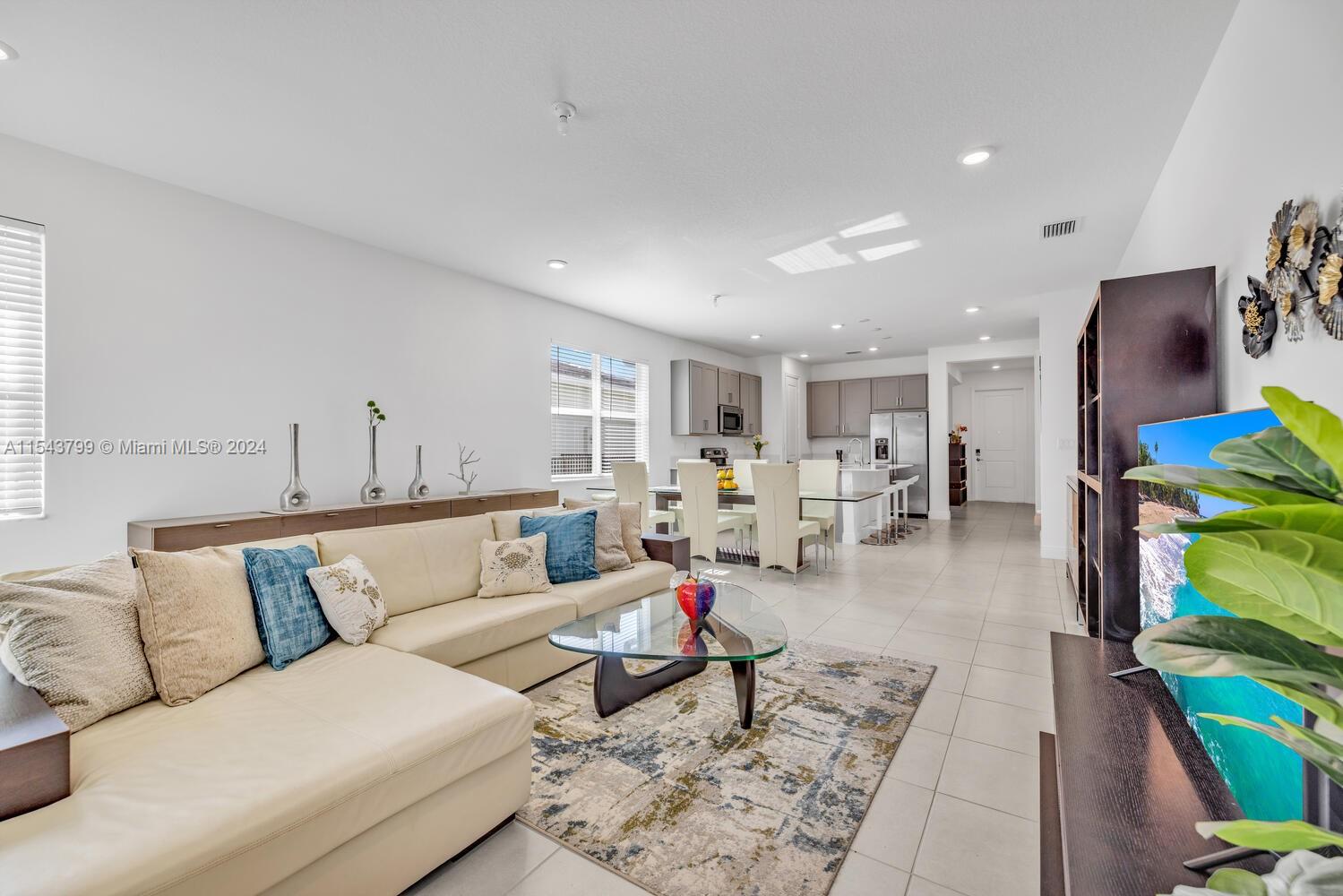 4242 Rosa Drive, Unit 4242 Deerfield Beach, FL 33064 - Photo 11 of 32 a living room with furniture and a flat screen tv