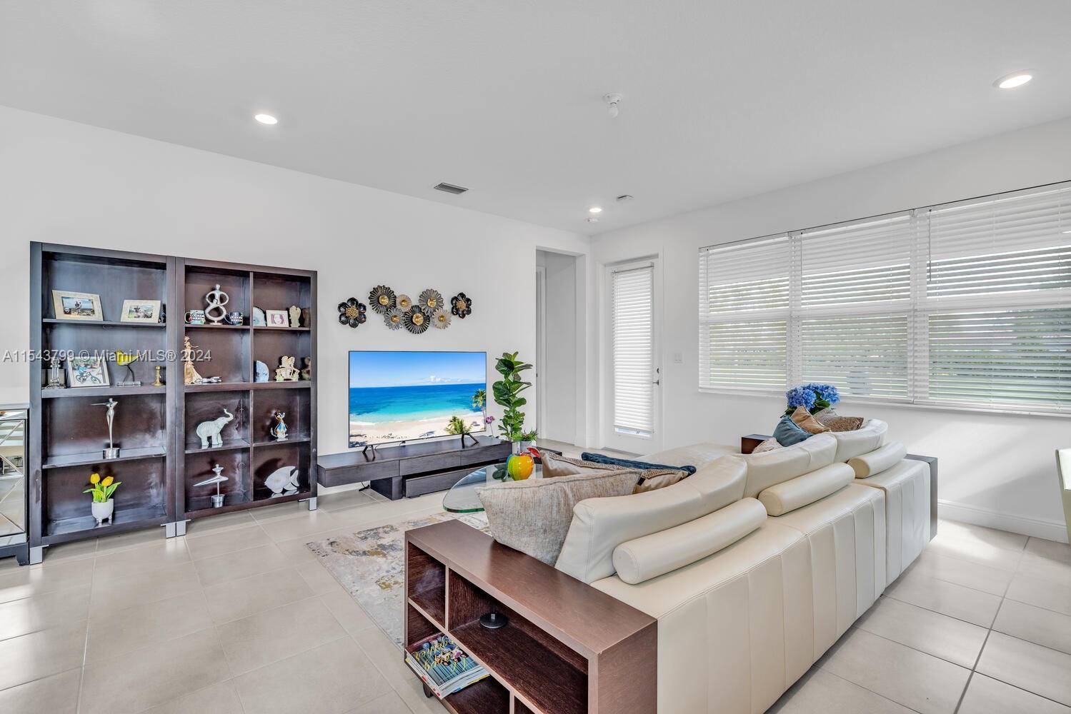 4242 Rosa Drive, Unit 4242 Deerfield Beach, FL 33064 - Photo 13 of 32 a living room with furniture and a flat screen tv