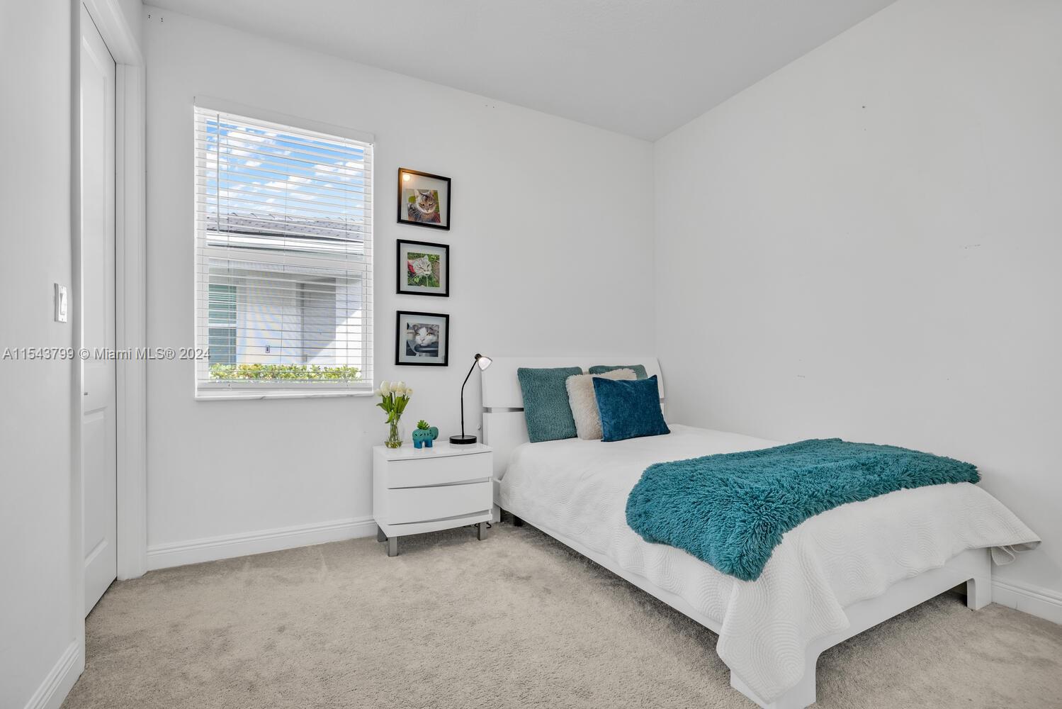 4242 Rosa Drive, Unit 4242 Deerfield Beach, FL 33064 - Photo 14 of 32 a bedroom with a bed and painting on the wall