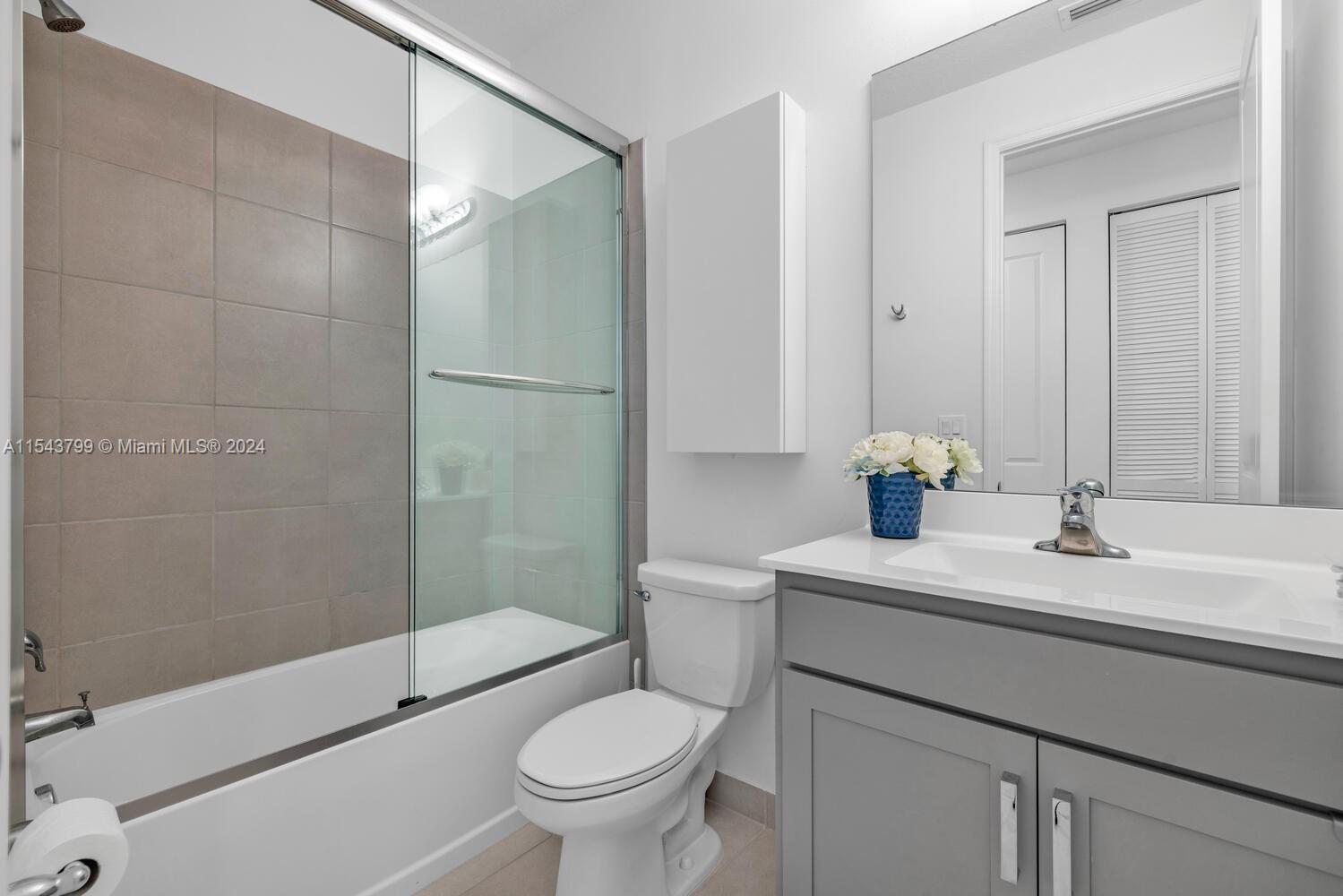 4242 Rosa Drive, Unit 4242 Deerfield Beach, FL 33064 - Photo 15 of 32 a bathroom with a sink toilet and shower
