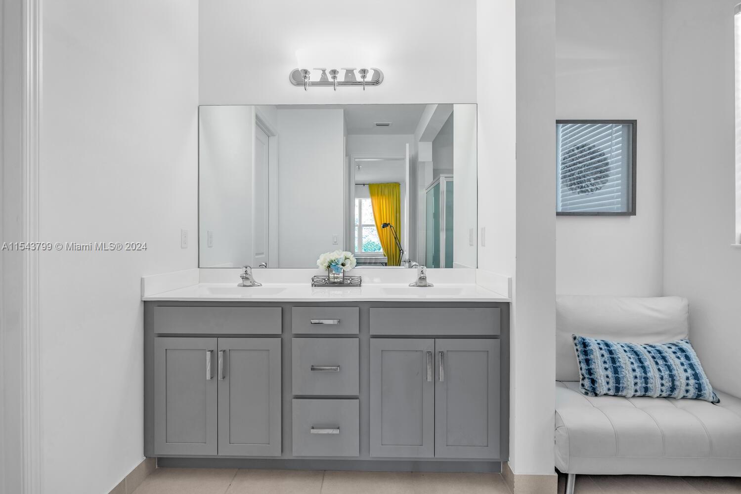4242 Rosa Drive, Unit 4242 Deerfield Beach, FL 33064 - Photo 19 of 32 a bathroom with a sink and a mirror