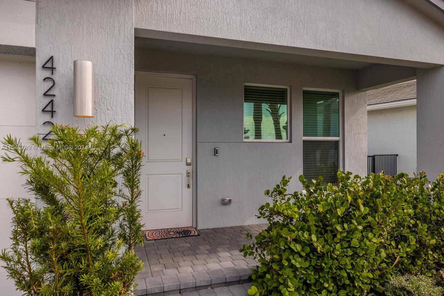 4242 Rosa Drive, Unit 4242 Deerfield Beach, FL 33064 - Photo 2 of 32 a front view of a house with a yard