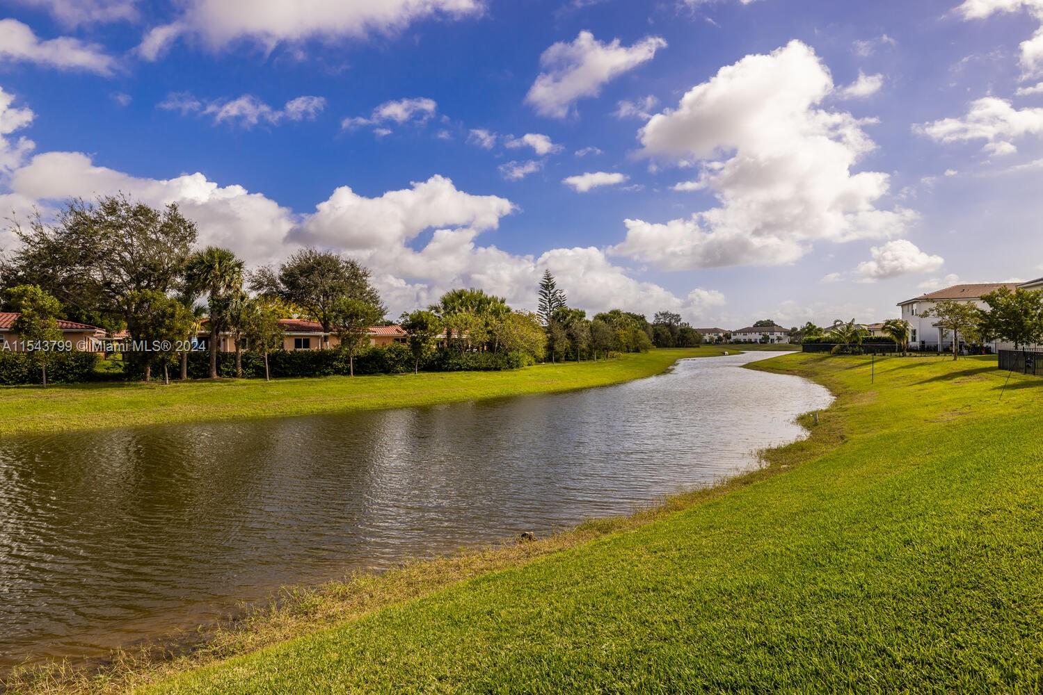 4242 Rosa Drive, Unit 4242 Deerfield Beach, FL 33064 - Photo 25 of 32 a view of a lake with houses in the background