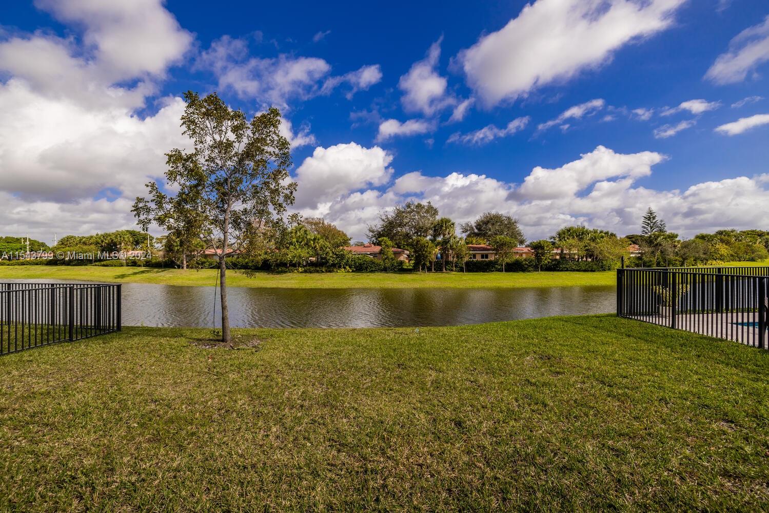 4242 Rosa Drive, Unit 4242 Deerfield Beach, FL 33064 - Photo 27 of 32 a view of a lake with houses in the back