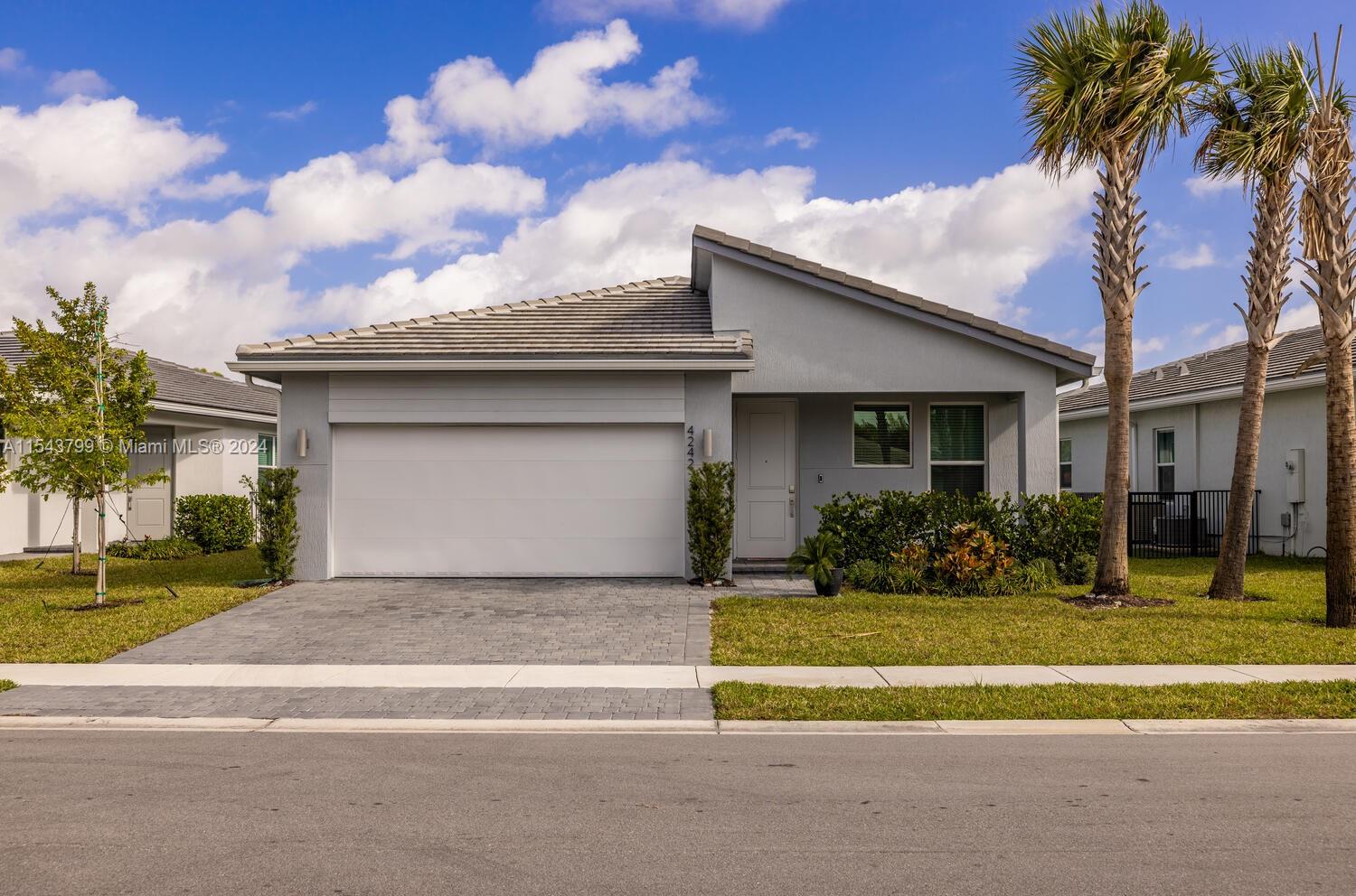 4242 Rosa Drive, Unit 4242 Deerfield Beach, FL 33064 - Photo 32 of 32 a front view of a house with a yard