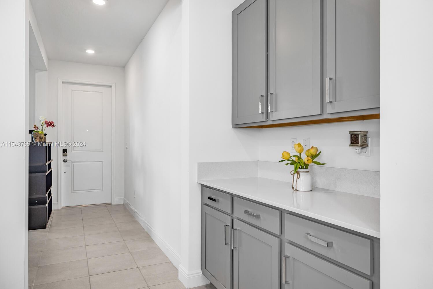 4242 Rosa Drive, Unit 4242 Deerfield Beach, FL 33064 - Photo 5 of 32 a hallway with white cabinets