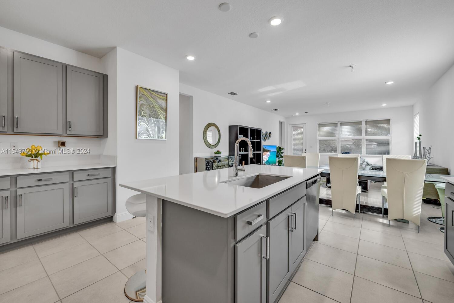 4242 Rosa Drive, Unit 4242 Deerfield Beach, FL 33064 - Photo 8 of 32 a kitchen with a sink and cabinets