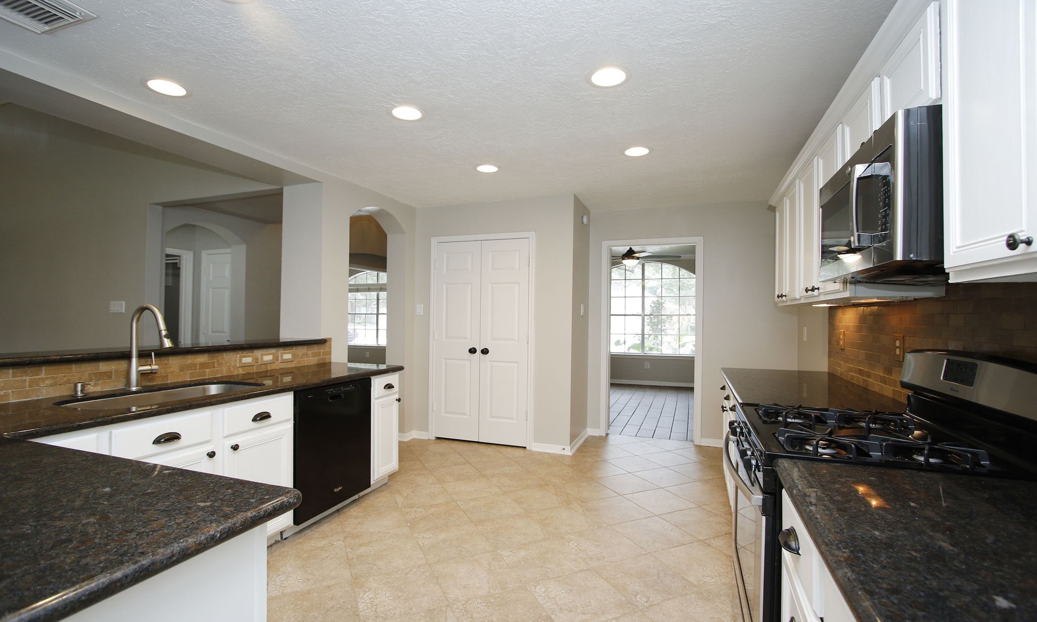 1915 West Welsford Drive Spring, TX 77386 - Photo 19 of 48 a kitchen with granite countertop a stove and a sink