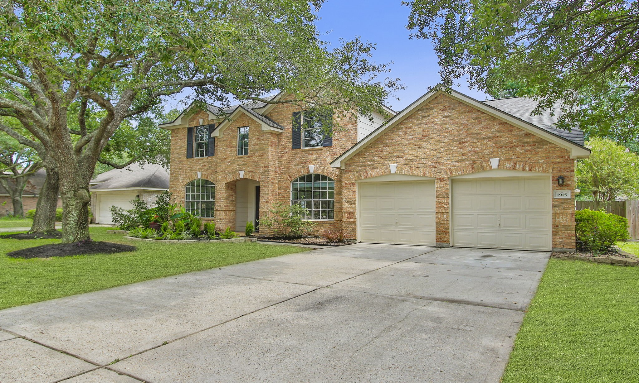 1915 West Welsford Drive Spring, TX 77386 - Photo 2 of 48 a view of a white house with a yard and large trees