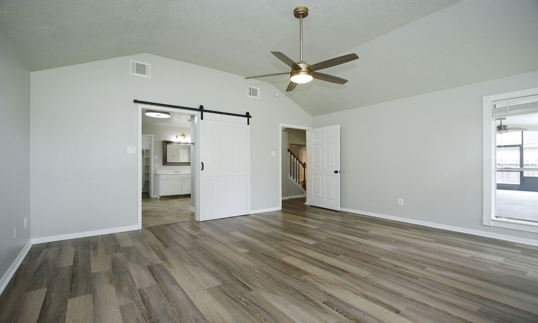 1915 West Welsford Drive Spring, TX 77386 - Photo 26 of 48 Barn Doors to Primary Bathroom