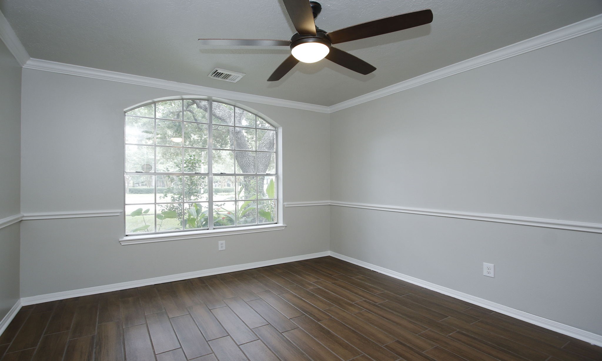 1915 West Welsford Drive Spring, TX 77386 - Photo 10 of 48 an empty room with wooden floor fan and windows