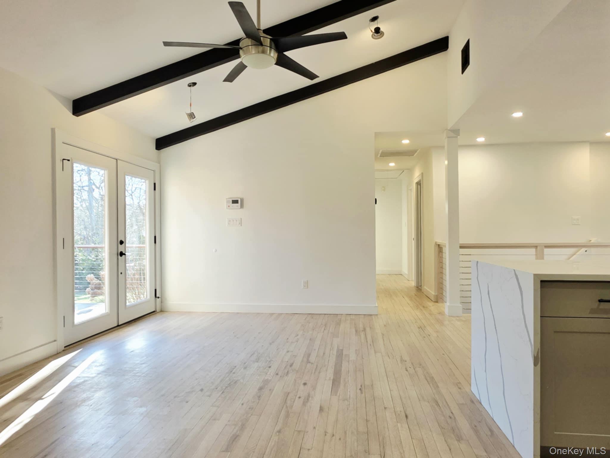 185 Wakeman Road Hampton Bays, NY 11946 - Photo 6 of 19 Unfurnished living room featuring french doors, light wood-type flooring, a ceiling fan, and recessed lighting