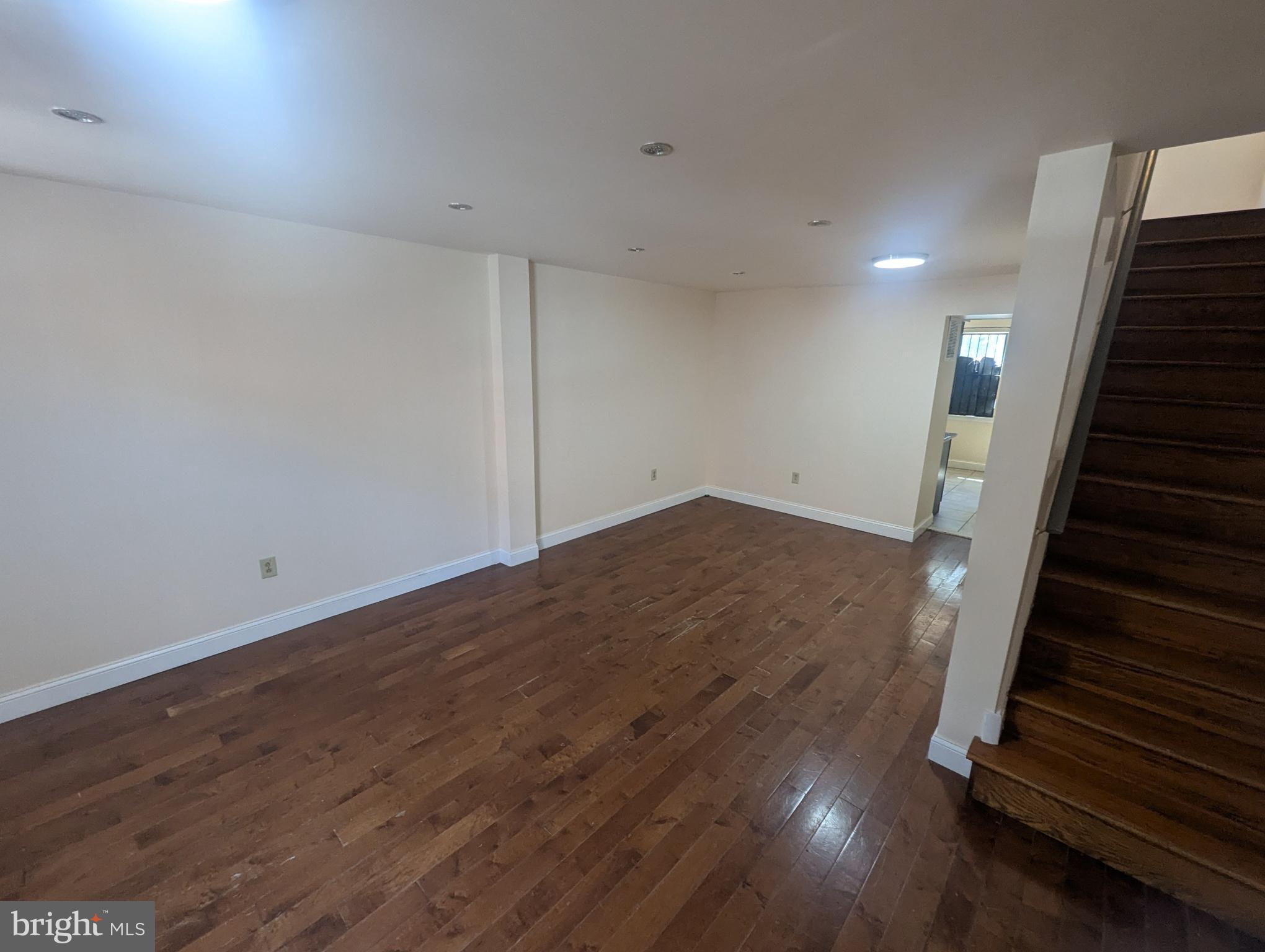 an empty room with wooden floor