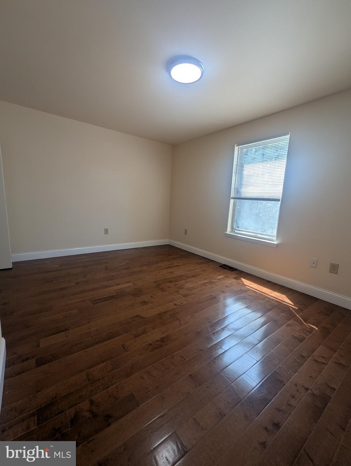 1624 West Diamond Street Philadelphia, PA 19121 - Photo 11 of 38 an empty room with wooden floor and windows