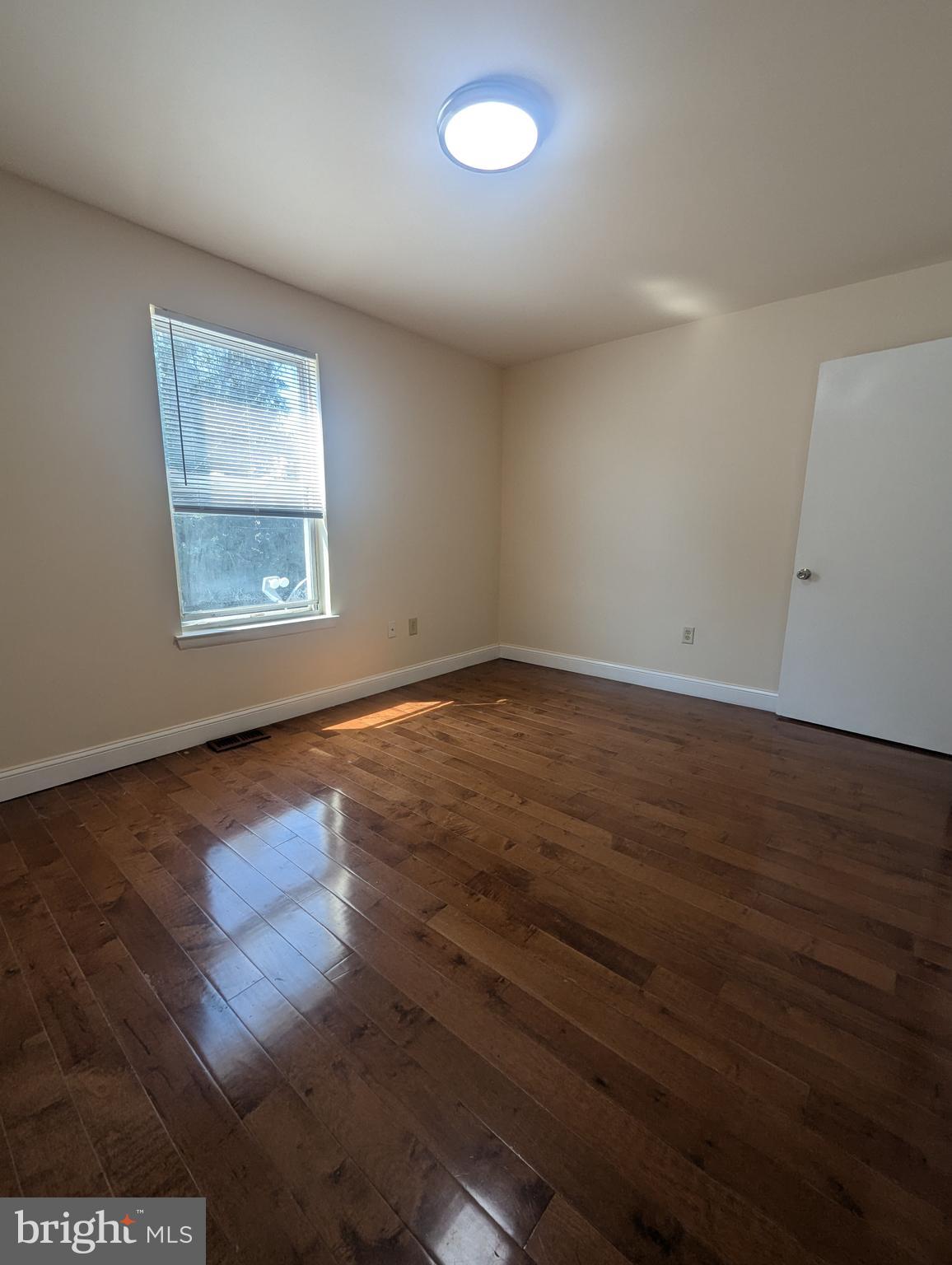 1624 West Diamond Street Philadelphia, PA 19121 - Photo 13 of 38 an empty room with wooden floor and windows