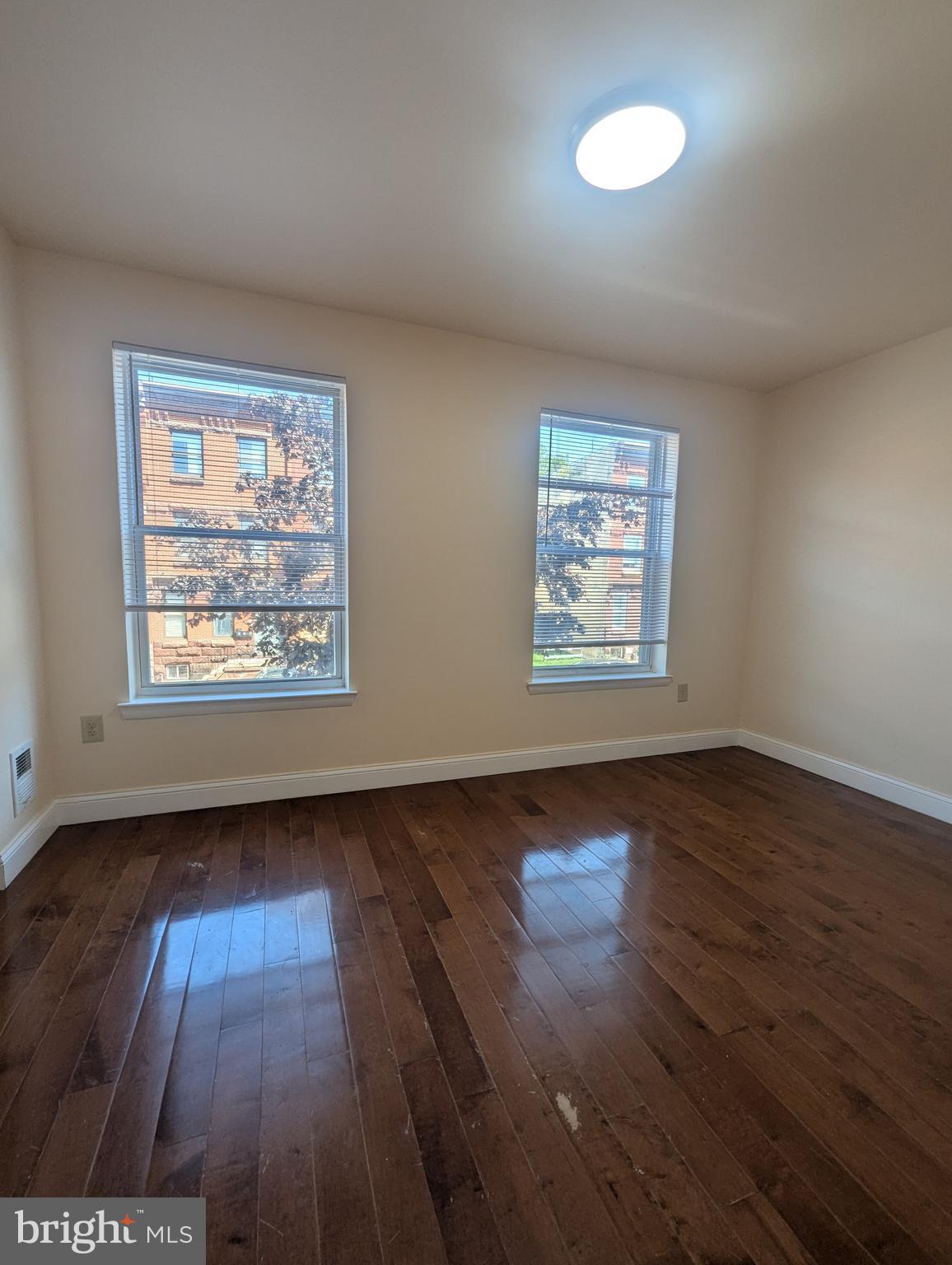 1624 West Diamond Street Philadelphia, PA 19121 - Photo 17 of 38 an empty room with wooden floor and windows