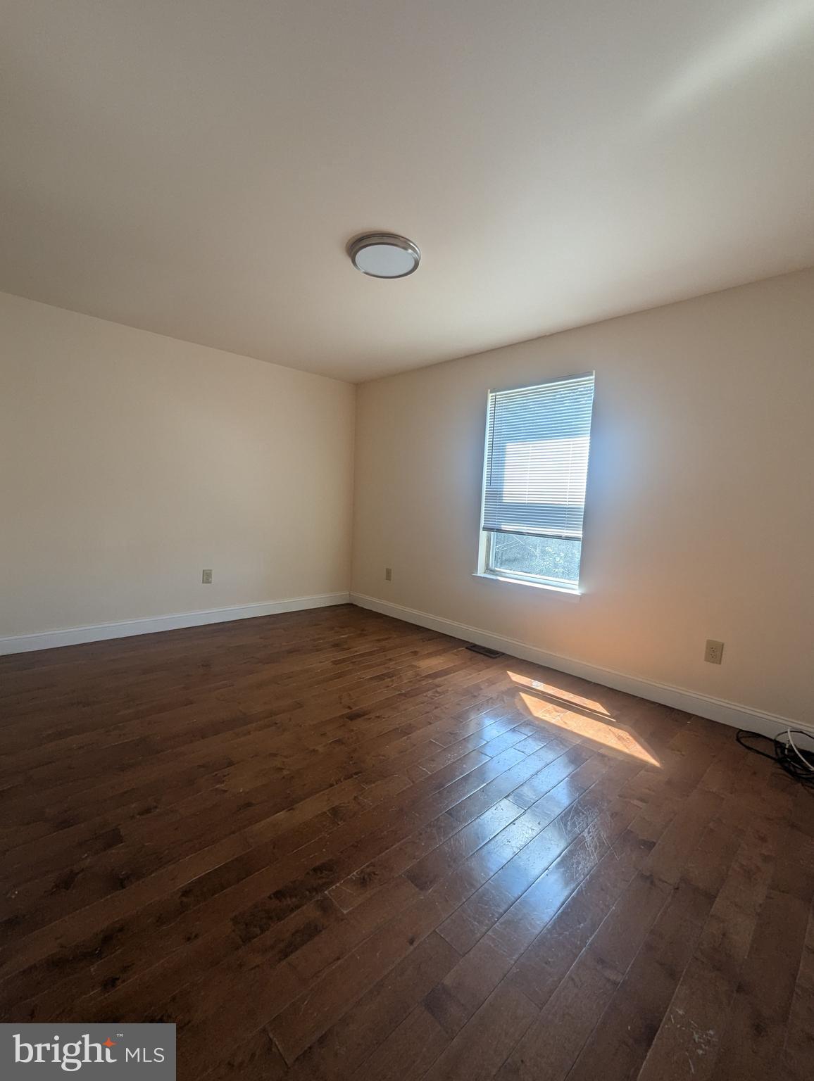 1624 West Diamond Street Philadelphia, PA 19121 - Photo 20 of 38 an empty room with wooden floor and windows