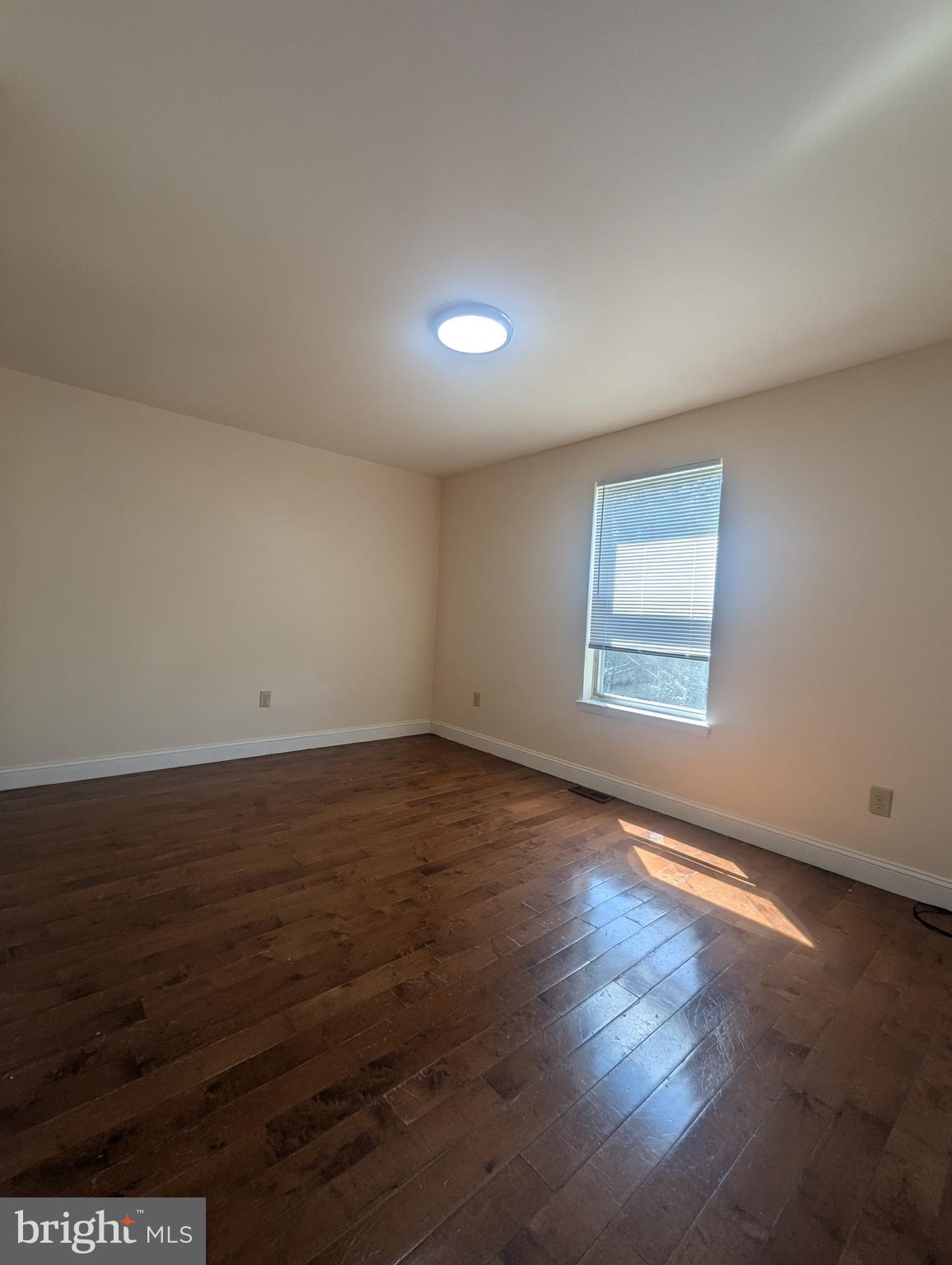 1624 West Diamond Street Philadelphia, PA 19121 - Photo 21 of 38 an empty room with wooden floor and windows