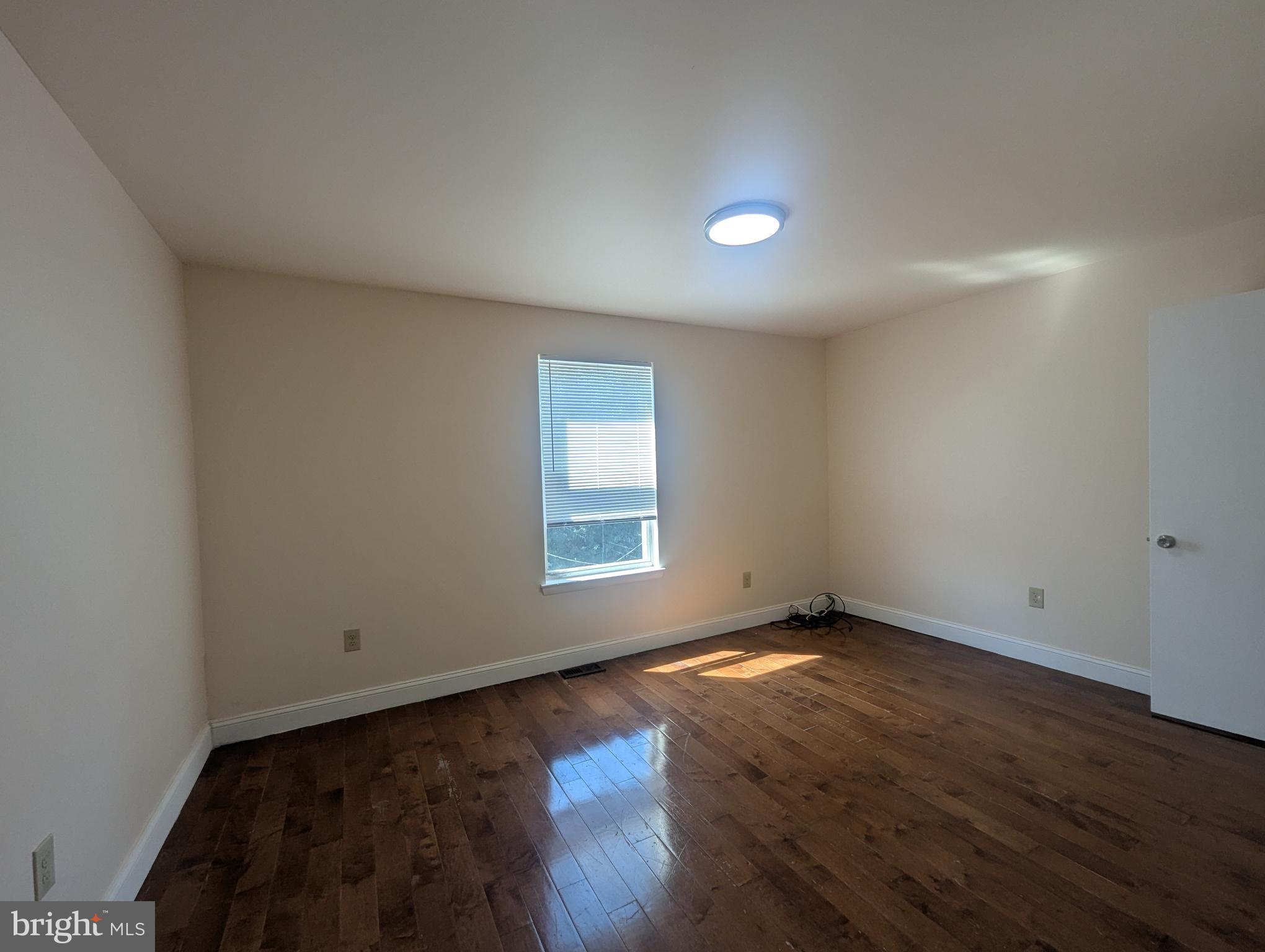 1624 West Diamond Street Philadelphia, PA 19121 - Photo 24 of 38 an empty room with wooden floor and windows