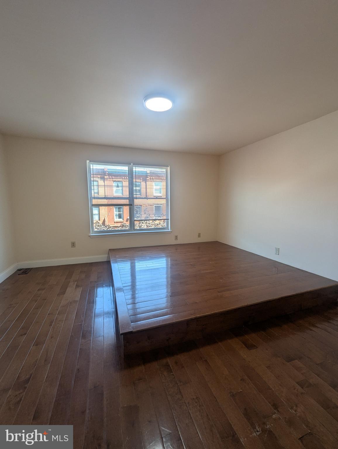 1624 West Diamond Street Philadelphia, PA 19121 - Photo 26 of 38 an empty room with wooden floor and windows