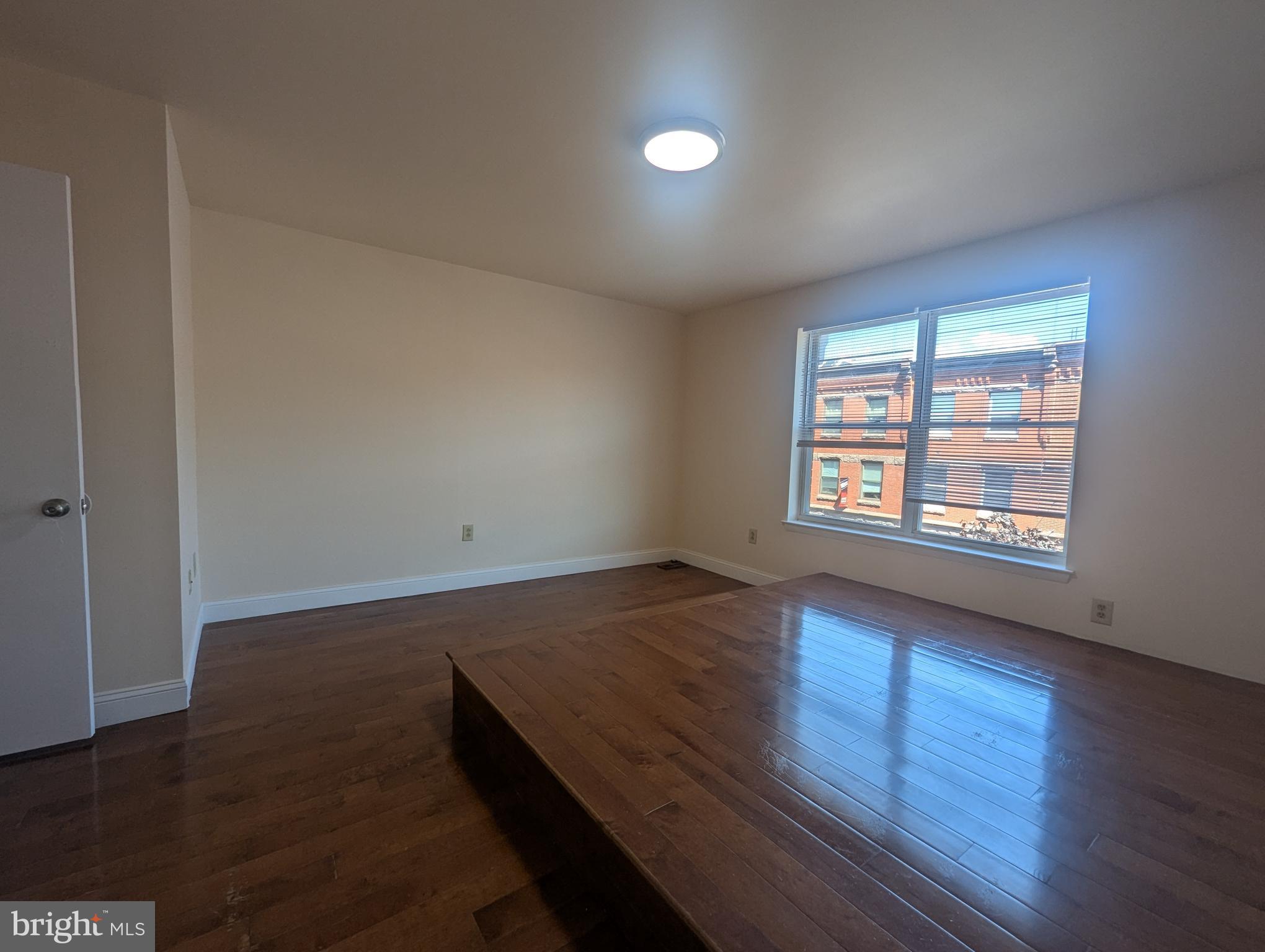 1624 West Diamond Street Philadelphia, PA 19121 - Photo 27 of 38 an empty room with wooden floor and windows