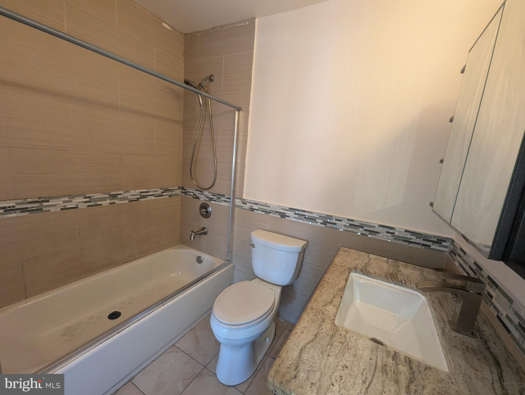 1624 West Diamond Street Philadelphia, PA 19121 - Photo 30 of 38 a bathroom with a granite countertop bathtub shower and toilet