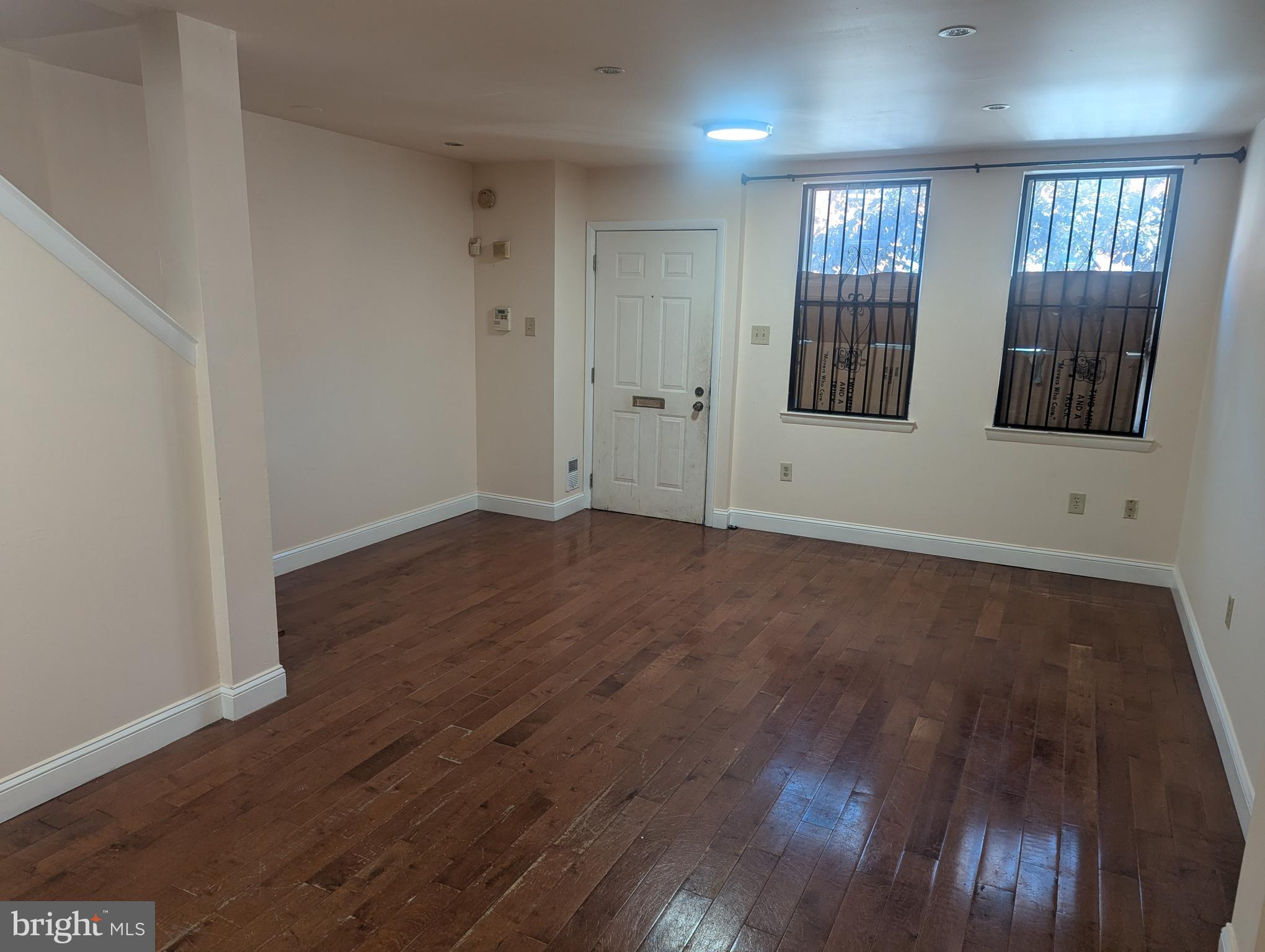 1624 West Diamond Street Philadelphia, PA 19121 - Photo 5 of 38 an empty room with wooden floor and windows