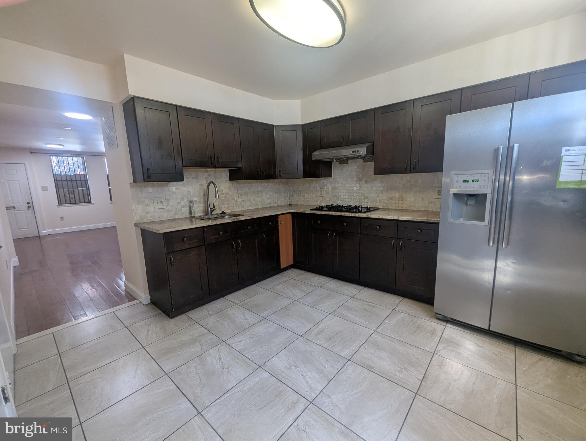 1624 West Diamond Street Philadelphia, PA 19121 - Photo 7 of 38 a kitchen with stainless steel appliances granite countertop a sink and a refrigerator