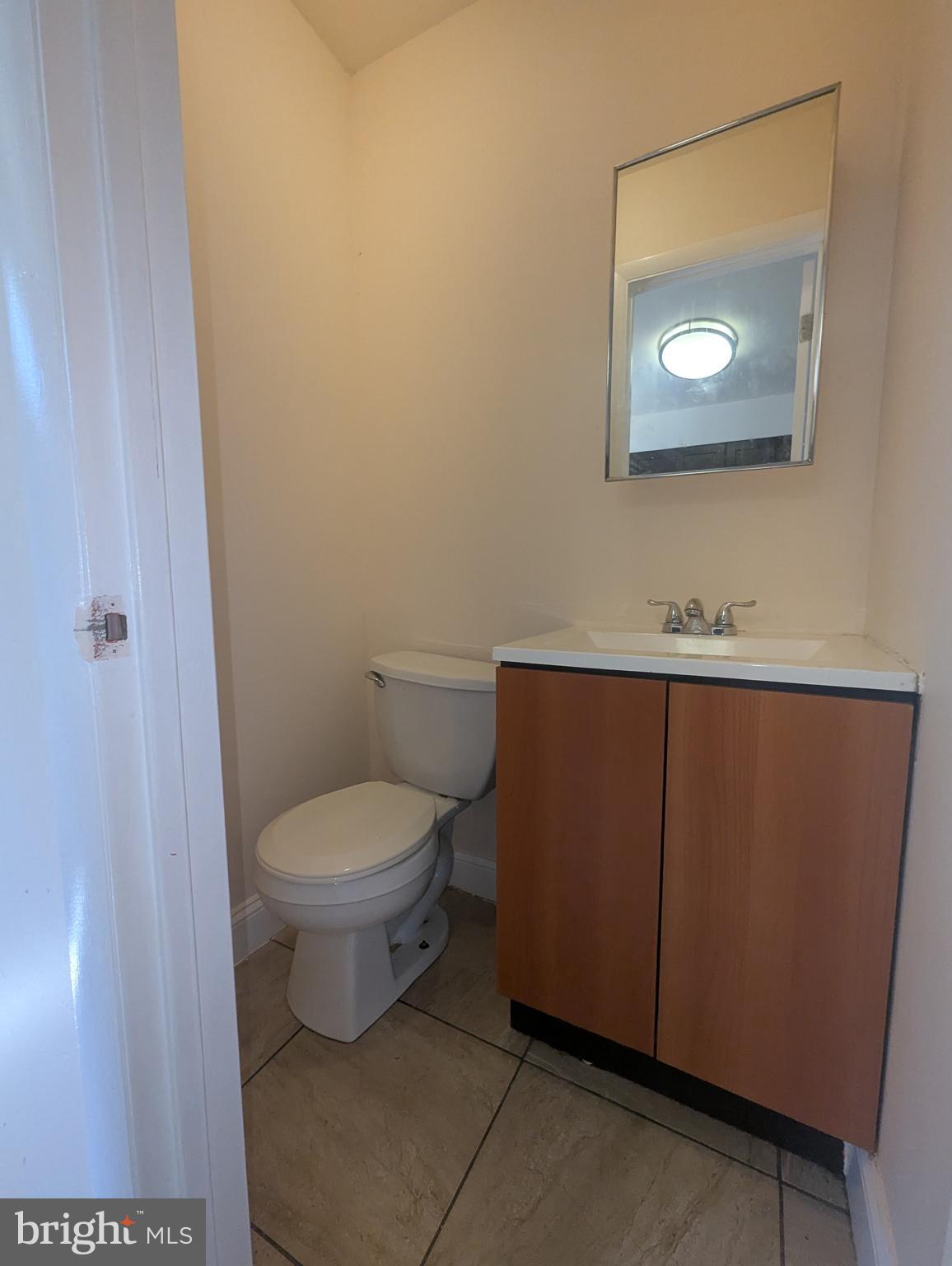 1624 West Diamond Street Philadelphia, PA 19121 - Photo 9 of 38 a bathroom with a toilet a sink and mirror