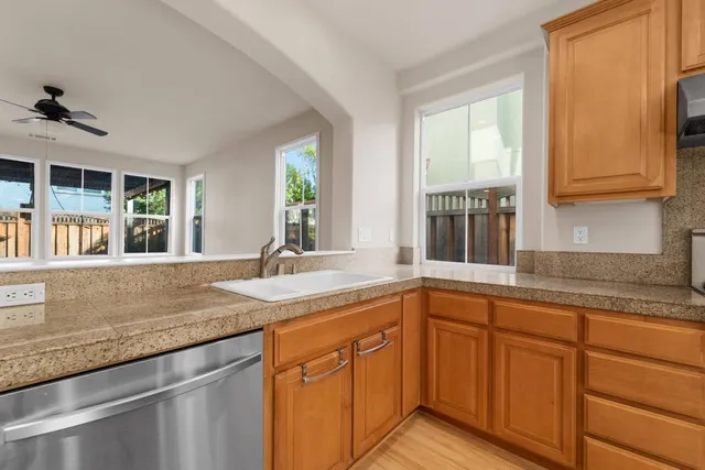a kitchen with granite countertop a sink and a window