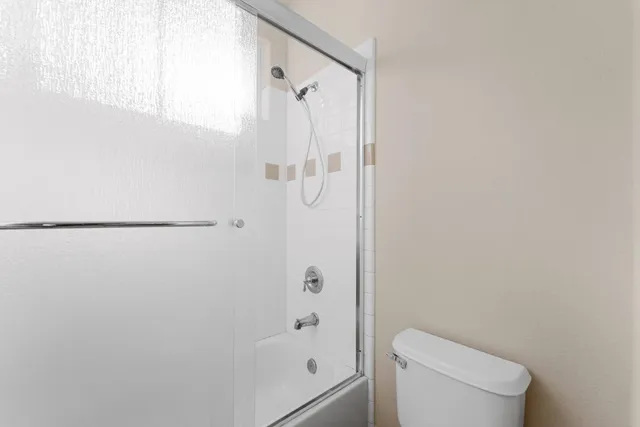 a bathroom with a shower and a toilet