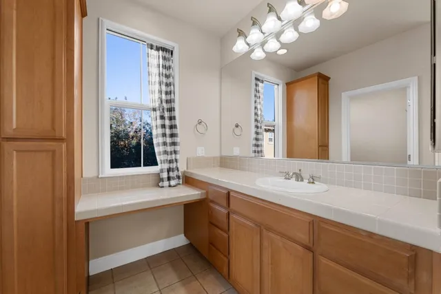 a bathroom with a sink a vanity and a mirror