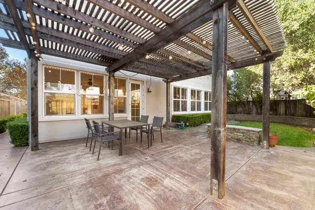 a view of a house with backyard porch and sitting area