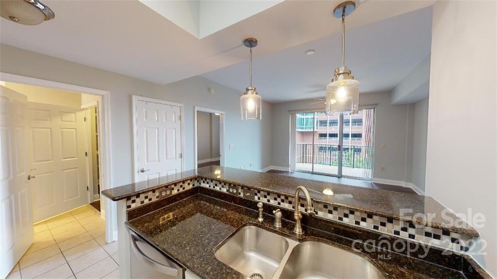 300 West 5th Street, Unit 339 Charlotte, NC 28202 - Photo 11 of 40 a kitchen with a table chairs and a stove