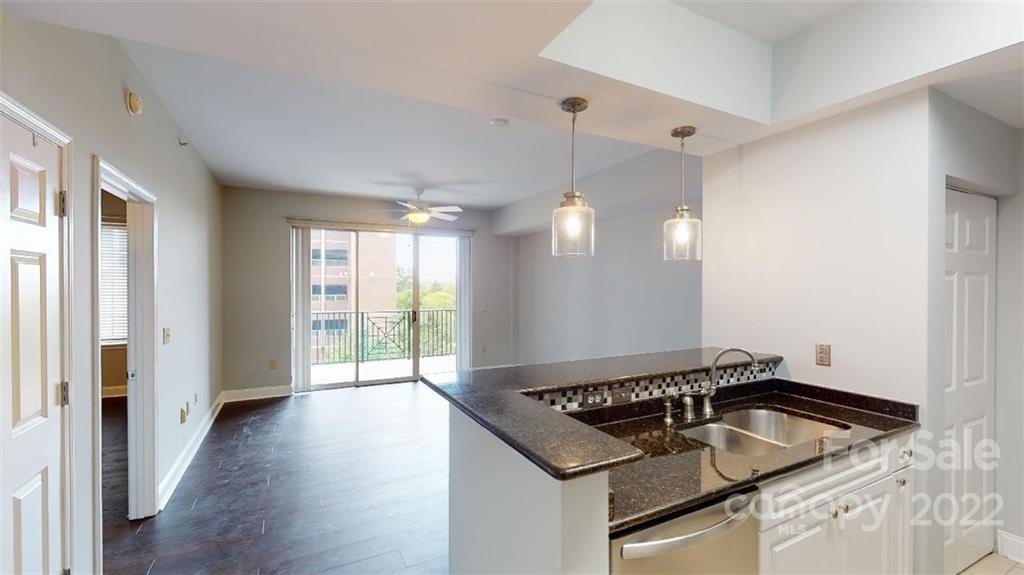 300 West 5th Street, Unit 339 Charlotte, NC 28202 - Photo 12 of 40 a kitchen that has a sink a stove and wooden floor