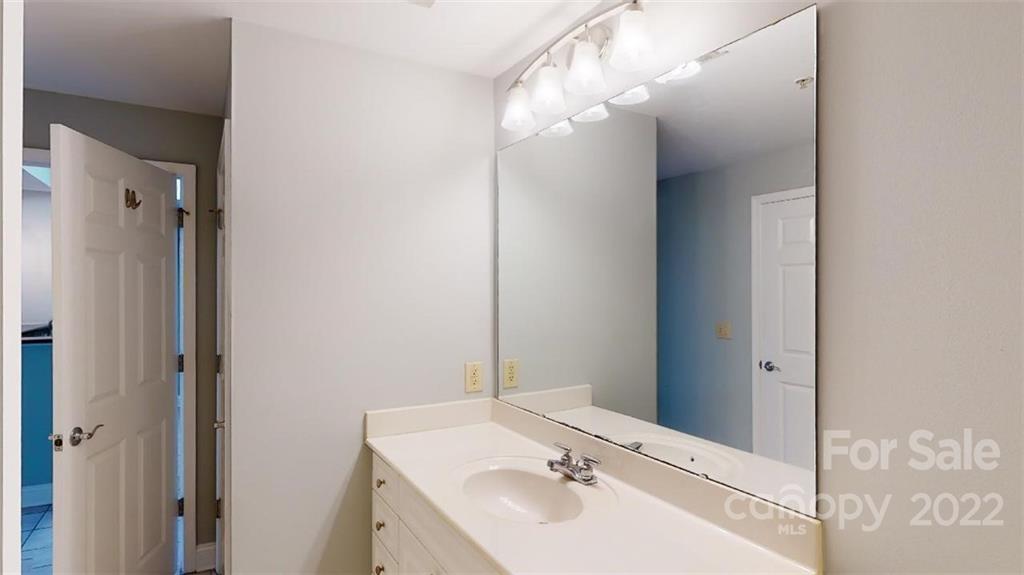 300 West 5th Street, Unit 339 Charlotte, NC 28202 - Photo 13 of 40 a bathroom with a sink a mirror and a shower