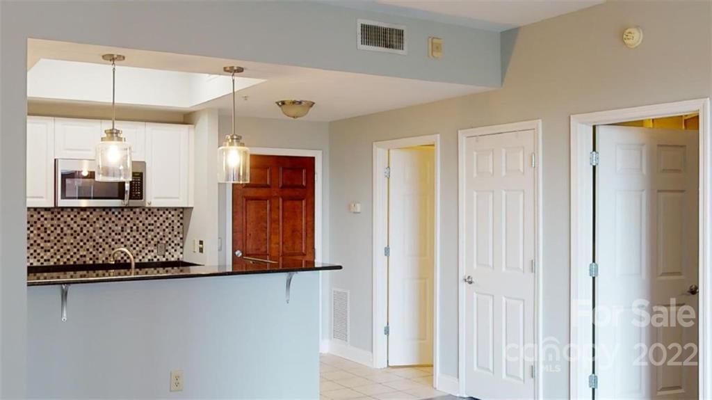 300 West 5th Street, Unit 339 Charlotte, NC 28202 - Photo 17 of 40 a living room with a couch and wooden floor