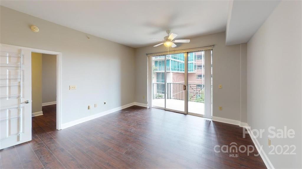300 West 5th Street, Unit 339 Charlotte, NC 28202 - Photo 21 of 40 an empty room with wooden floor and a window